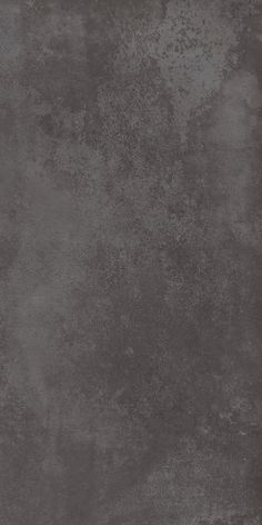 an image of a grungy concrete wall textured with dark gray paint and stains