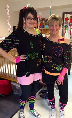 two women standing next to each other wearing matching outfits