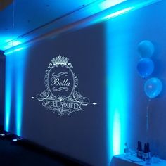 a room with blue lights and balloons on the wall