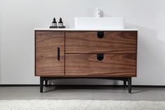 a bathroom with a sink and wooden cabinet