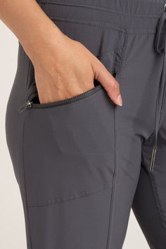 An easy-fit cut paired with elastic drawstring has Runyon racing to be your #1. With front zip pockets and a drawstring waist, being active has never looked better! Whisper Stretch: 88/12 Polyester/Spandex. Inseam: ~30" Front Rise: ~10.5" Back Rise: ~16.25" Waistband: .75" Elastic waistband with drawstring Color Description: Our favorite dark grey Preshrunk. Machine washable. Imported. MODEL Kerry is wearing size Small. Height: 5"10' | Bust: 34B | Waist: 27" | Hip: 37.5" Utility Style Joggers With Functional Pockets For Sports, Athleisure Outdoor Pants With Drawstring, Athleisure Drawstring Joggers For Outdoor, Outdoor Athleisure Joggers With Drawstring, Gray Nylon Activewear With Pockets, Athleisure Activewear With Drawstring For Outdoor Activities, Functional Drawstring Workout Bottoms, Functional Workout Bottoms With Drawstring, Sporty Nylon Joggers With Drawstring