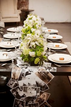 a long table is set with photos and flowers