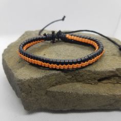 If you like orange and black, then this simple bracelet is perfect for you to add to your collection. The bracelet is adjustable via a sliding knot. Product Information Material: PU leather Clasp Type: rope (sliding knot) Adjustable: 6.5 inches to 8 inches Casual Orange Braided Bracelets For Friendship, Casual Orange Braided Bracelet For Friendship, Black Leather Bracelet With Adjustable Band, Adjustable Orange Beaded Bracelets For Everyday, Black Adjustable Leather Bracelet, Adjustable Sliding Knot Friendship Bangle, Orange Casual Everyday Bracelet, Everyday Casual Orange Bracelet, Handmade Adjustable Orange Bracelets