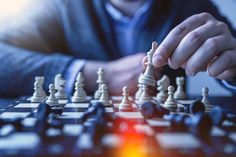 a man is playing chess on a table