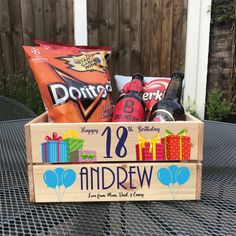 a wooden crate filled with beer and snacks