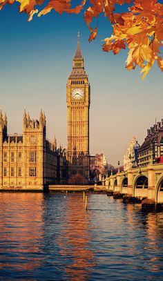 the big ben clock tower towering over the city of london, england in autumn time