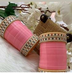 two pink vases sitting next to each other on a table