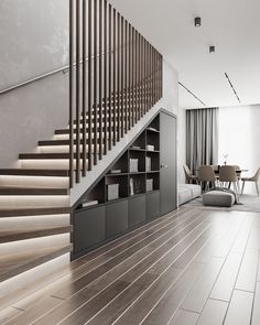 a living room filled with furniture and a stair case next to a wooden table on top of a hard wood floor