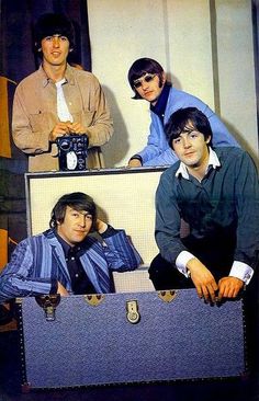 the beatles are posing in their suitcases for a photo shoot, with one man holding his camera