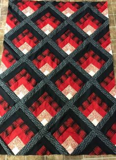 a red and black quilt on the floor