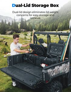 a man working on the back of a utility vehicle with an advertisement for dual - lid storage box