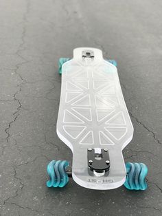 a skateboard with blue wheels is on the ground