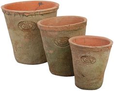 three clay pots sitting next to each other