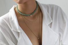 Experience the serene elegance of our Green Aventurine Beaded Necklace. Centered with a dainty Cubic Zirconia charm, this piece encapsulates subtle luxury. The necklace is secured with a gold clasp, offering both sophistication and durability. Customize the length to fit your unique style and make it a versatile addition to your jewelry collection. Whether it's a personal treat or a thoughtful gift, this necklace is an embodiment of grace and craftsmanship. Serene Green Aventurine Dainty Cubic Z Subtle Luxury, Green Aventurine, Versatile Style, Metal Stamping, Round Shape, Natural Stone, Thoughtful Gifts, Make It, Gold Filled