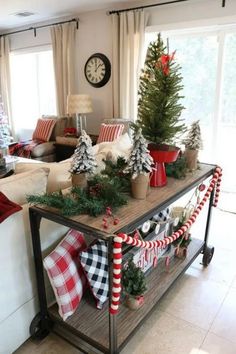 a living room with christmas decorations on the table