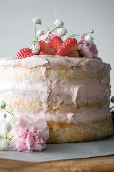 a cake with frosting and strawberries on top