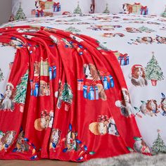 a bed covered in red and white christmas themed sheets