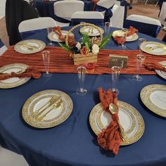 a table set with plates and place settings