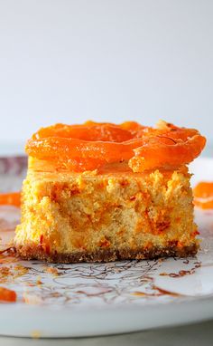 a piece of cake on a plate with orange sauce around the edges and one slice missing