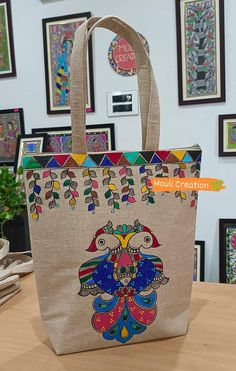 an image of a bag on display in a store or office setting with art work behind it