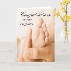 a congratulations card with a baby's foot on it