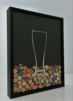 a beer glass sitting on top of a pile of buttons