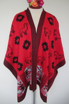 "One size fits most women This Ruana is elegant and sophisticate, it has a \"V\" neckline, drop shoulders style and Llama motifs in black/Red all around. It is reversible. It is knitted of baby rabbit acrylic wool, which is unbelievable soft and warm. It is perfect to throw on to feel warm and cozy for any occasion, on date nights or informal meetings with your family and friends. Made in Peru. Color Red/Black Super Soft Wrap Made of baby rabbit wool acrylic One Size, Approximate dimensions: 40\ One Size Alpaca Poncho, Wool Knit Scarf, Linen Shawl, Cape Wrap, Baby Rabbit, Hand Knit Shawl, Mesh Sweater, Chunky Knit Scarves, Chiffon Shawl