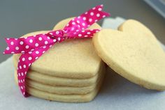 some cookies are stacked on top of each other with a pink polka dot ribbon around them