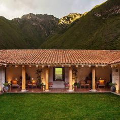 an outdoor patio with mountains in the background and grass on the ground to the side