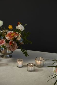 flowers and candles are sitting on a table