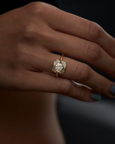 a woman's hand with a diamond ring on it