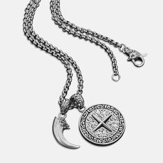 The ancient art of falconry was not only a form of hunting in Medieval culture, but also a symbol of discipline and mastery. As an ode to this cherished tradition, the Falconer pendant features imagery of two noble falcons and a handcrafted talon charm. Handcrafted sterling silver pendant, charm, and clasps. Stainless steel 55cm x 3mm cable chain. Antique Silver Medieval Jewelry With Oxidized Finish, Medieval Jewelry In Antique Silver With Oxidized Finish, Medieval Sterling Silver Jewelry In Antique Silver, Medieval Silver Cross Pendant Jewelry, Medieval Engraved Cross Pendant Jewelry, Medieval Style Engraved Antique Silver Jewelry, Sterling Silver Amulet Medallion Necklace, Medieval Sterling Silver Pendant Jewelry, Medieval Style Silver Engraved Necklace