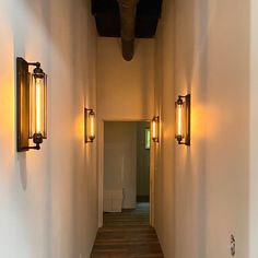 a long hallway with two lights on either side and another light on the other side