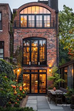 a brick building with lots of windows and plants