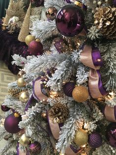 a christmas tree with purple and gold ornaments