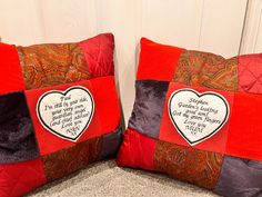 two red and brown pillows with a heart on them, one has a poem written on it