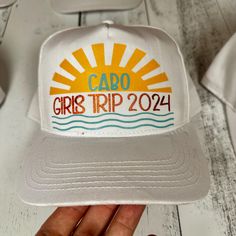 Get ready for your Cabo Girls Trip 2024 with these stylish and personalized snapback hats! These custom white snapback caps are perfect for adding a fun and unique touch to your bachelorette party or vacation. Each hat features a vibrant "Cabo Girls Trip 2024" design on the front, complete with a sun and waves graphic, and is personalized with initials on the back in bold, eye-catching colors. Key Features: Custom Design: Bright and colorful "Cabo Girls Trip 2024" graphic on the front. Personalized Touch: Each hat comes with custom initials on the back, making it easy to keep track of your own. High-Quality Material: Made from durable and comfortable fabric to withstand all your adventures. Adjustable Fit: The snapback closure ensures a perfect fit for everyone. Versatile Use: Perfect for Cheap Customizable Snapback Hat As Gift, White 5-panel Baseball Cap For Beach, Personalized White Baseball Cap With Curved Bill, White Curved Bill Baseball Cap As Gift, Personalized White Snapback Hat With Curved Bill, White Personalized Curved Bill Snapback Hat, Customizable White 5-panel Snapback Hat, Customizable White 5-panel Baseball Cap, Customizable White 5-panel Trucker Hat