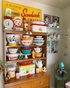 a wooden cabinet filled with lots of bowls and plates on top of it's sides