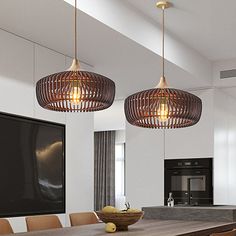 two lights hanging from the ceiling above a dining room table with chairs and a bowl on it