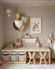 a child's room with toys and balloons on the wall