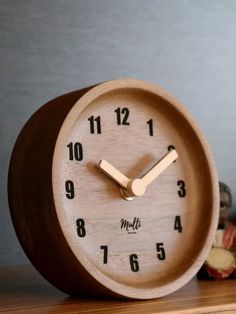 a wooden clock sitting on top of a table