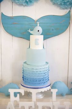 a blue and white cake sitting on top of a table