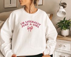 I'm Just a Girl Embroidered Crewneck With Bow (Pink Design). Please request custom threads colors via customization box. Otherwise embroidered as pictured -Soft & Comfortable: Made from a high-quality blend of cotton and polyester for ultimate comfort and durability. -Charming Design: Adorable "I'm literally just a girl" with a bow adds a playful touch to your outfit. -Embroidered Detail: Intricately embroidered for a premium look and feel. -Versatile Style Available in various sizes and colors to match your personal style. -Perfect Gift: Ideal for birthdays, holidays, or just because - a unique gift for girly girls Whether you're lounging at home, running errands, or enjoying a casual day out, this Cozy Embroidered Sweatshirt is the perfect blend of comfort and style. Order yours today an Pink Sweatshirt With Letter Print For Gifts, Pink Sweatshirt With Letter Print As Gift, Pink Letter Print Sweatshirt As Gift, Pink Letter Print Sweatshirt Gift, Pink Relaxed Fit Top For Gift, Pink Relaxed Fit Top As A Gift, Casual Pink Sweatshirt For Birthday, Pink Relaxed Fit Sweatshirt As Gift, Pink Long Sleeve Sweatshirt For Birthday