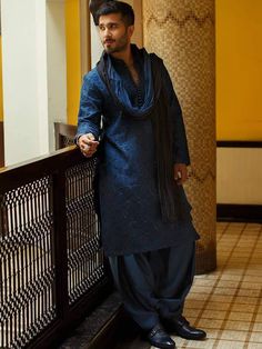 a man standing next to a railing in a building