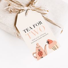 a tea for two gift tag on top of a wrapped present