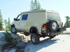 an off - road vehicle is parked on the side of a rock outcropping