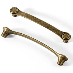 two antique brass handles on white background