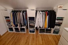 an organized closet with clothes and drawers