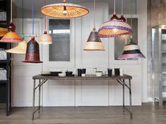 several lights hanging from the ceiling above a table