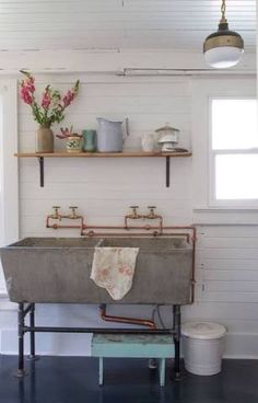 an old fashioned sink in the corner of a room